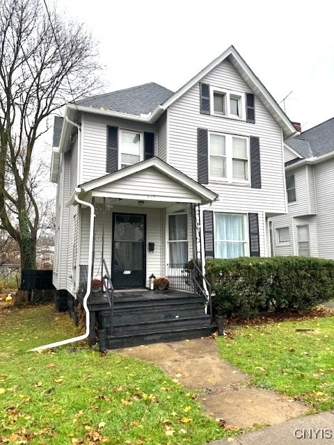 view of front of home with a porch and a front yard