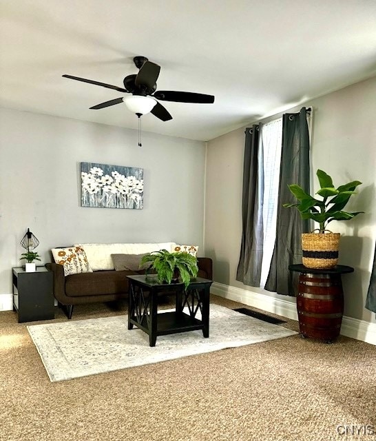 living room featuring carpet floors and ceiling fan