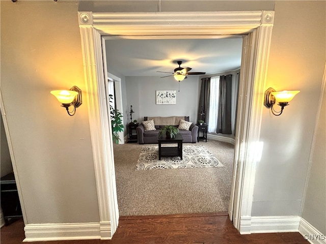 living room with ceiling fan and dark hardwood / wood-style floors