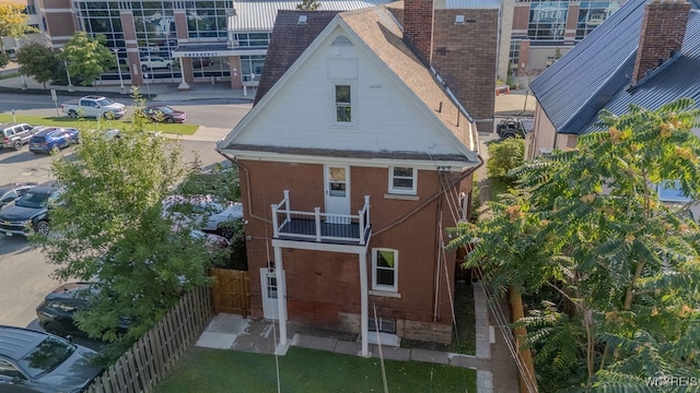 back of property featuring a balcony