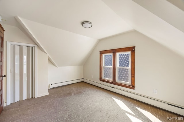 bonus room featuring a baseboard heating unit, vaulted ceiling, and hardwood / wood-style flooring