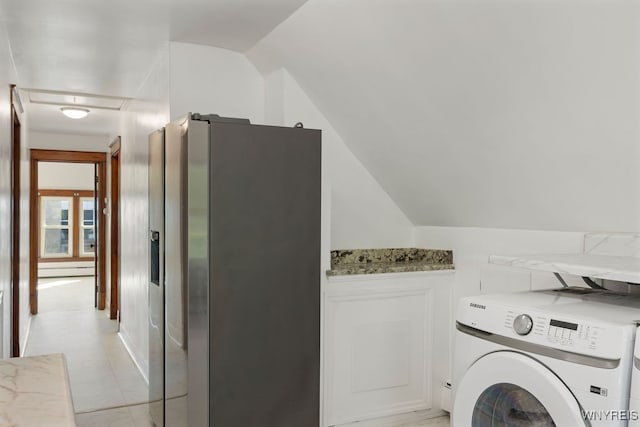 laundry area featuring light tile patterned floors and washer / clothes dryer