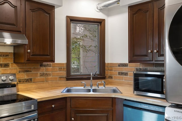 kitchen featuring dark brown cabinetry, sink, and appliances with stainless steel finishes