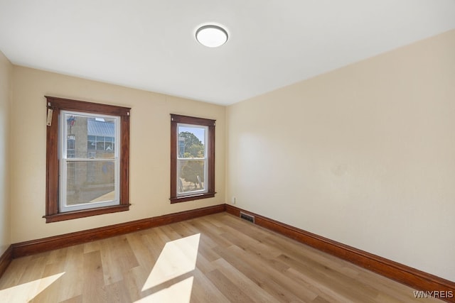 spare room with light hardwood / wood-style flooring