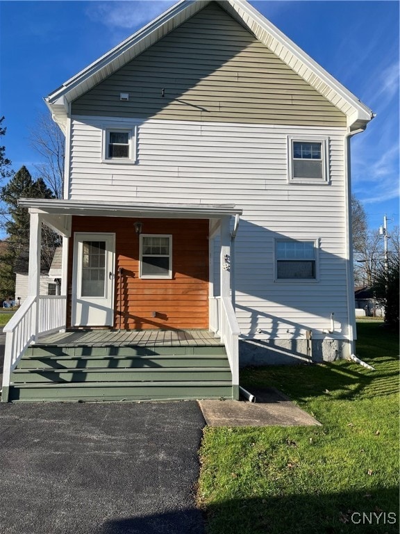 view of front of home featuring a front yard and a porch