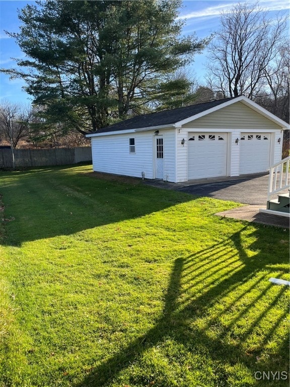 view of yard with a garage and an outdoor structure