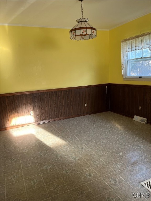 spare room featuring wood walls