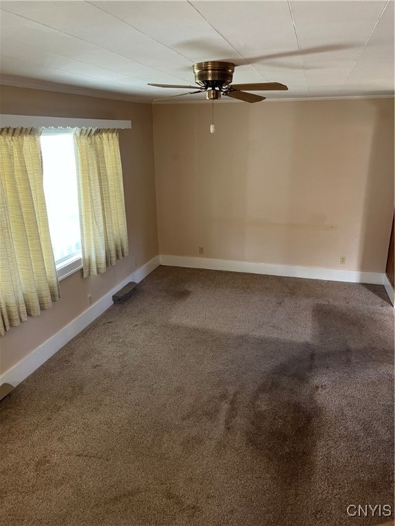 empty room with ceiling fan and carpet floors