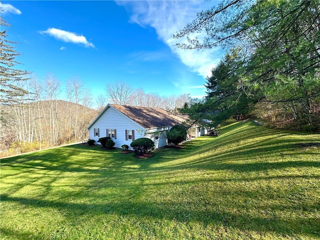 view of side of property with a lawn