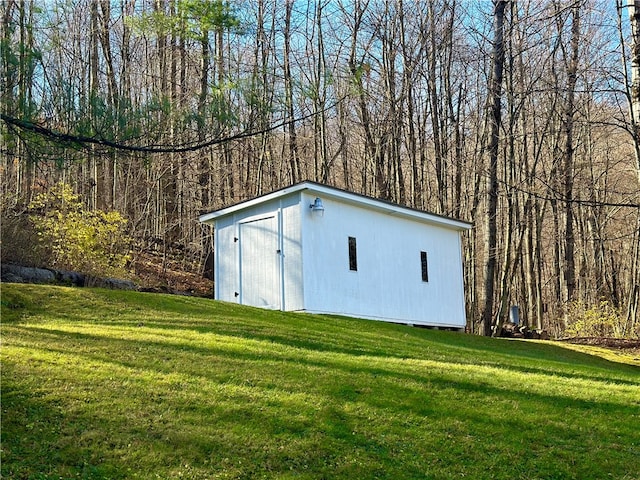 view of outdoor structure featuring a lawn