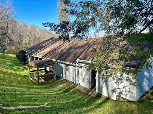 view of side of property with a yard