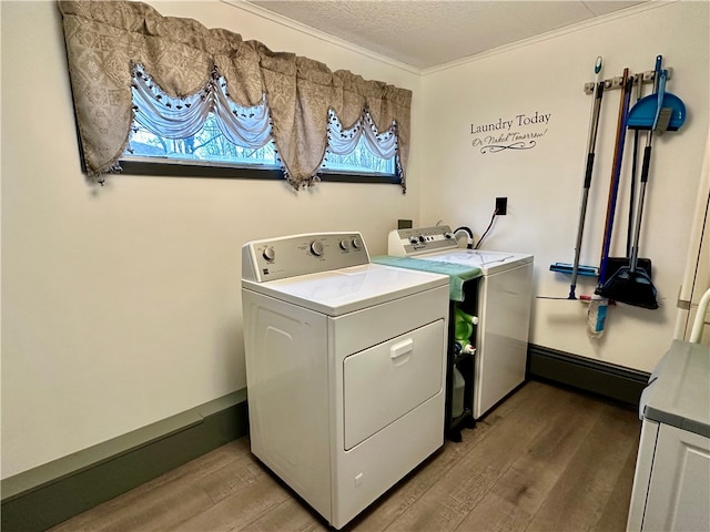 clothes washing area with hardwood / wood-style flooring, separate washer and dryer, a textured ceiling, and crown molding