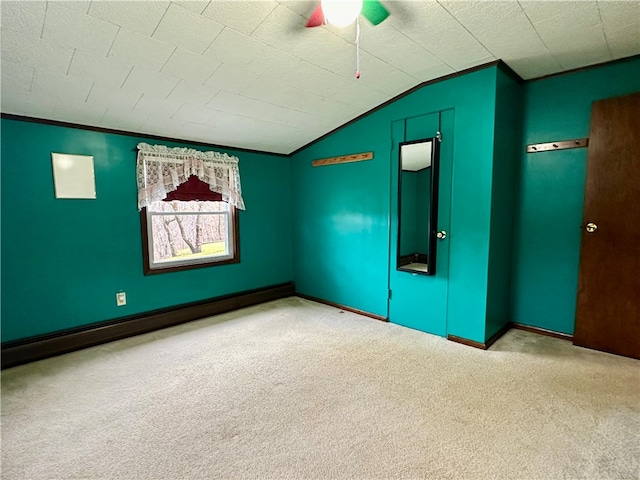 unfurnished room featuring lofted ceiling, light colored carpet, and baseboard heating