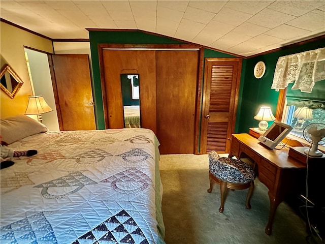 carpeted bedroom featuring wooden walls, ornamental molding, and vaulted ceiling