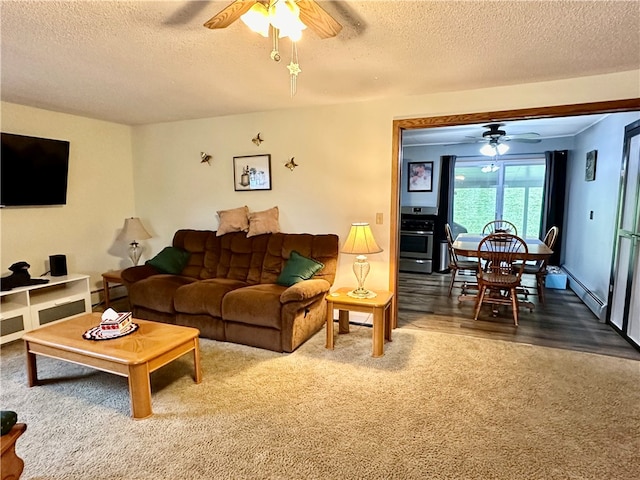 carpeted living room with ceiling fan, a textured ceiling, and a baseboard heating unit