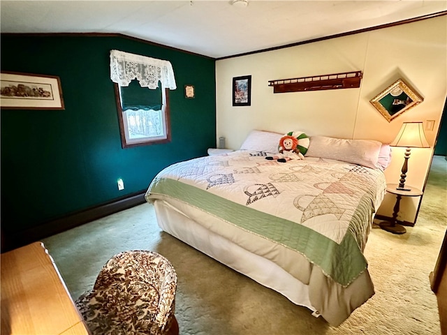 carpeted bedroom featuring ornamental molding and lofted ceiling