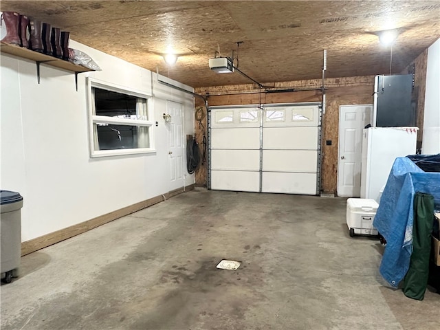 garage featuring white refrigerator and a garage door opener