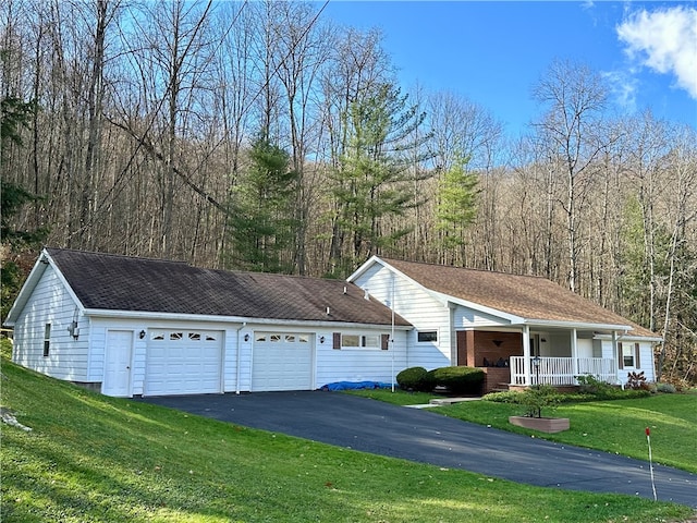 ranch-style house with a garage, a front yard, and a porch