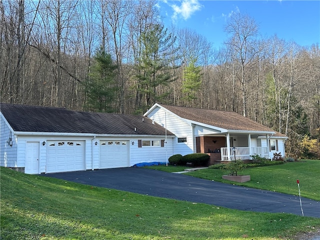 single story home with a porch, a garage, and a front lawn