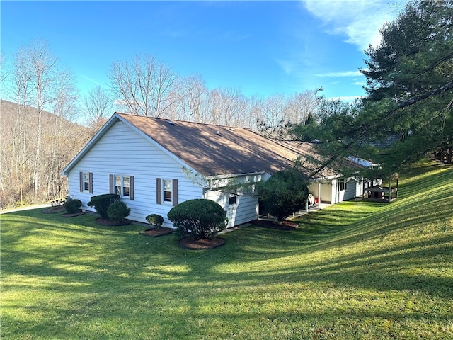 view of side of property featuring a yard