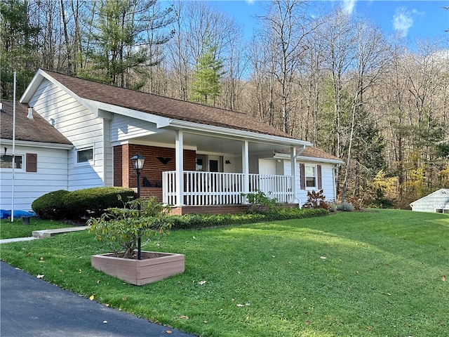 single story home featuring covered porch and a front lawn