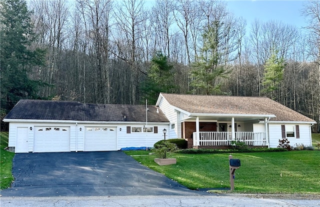 ranch-style home with a garage, a front lawn, and a porch