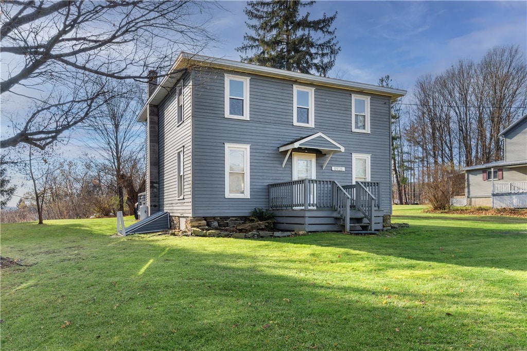 exterior space with a front yard and a deck