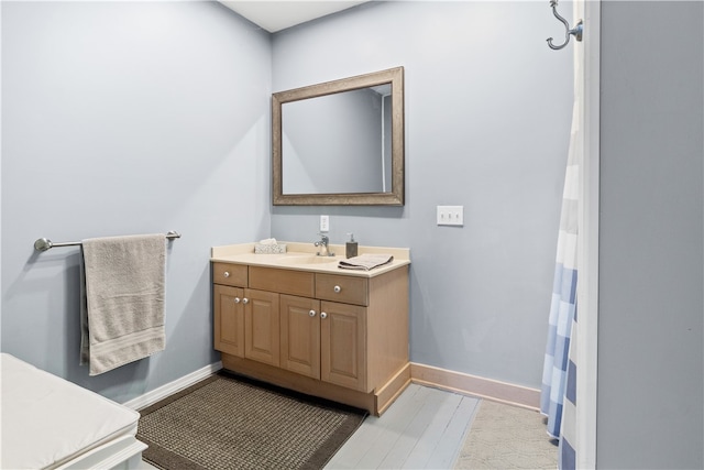 bathroom with hardwood / wood-style flooring and vanity