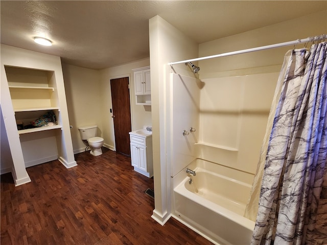 bathroom featuring shower / bath combo, wood-type flooring, a textured ceiling, and toilet