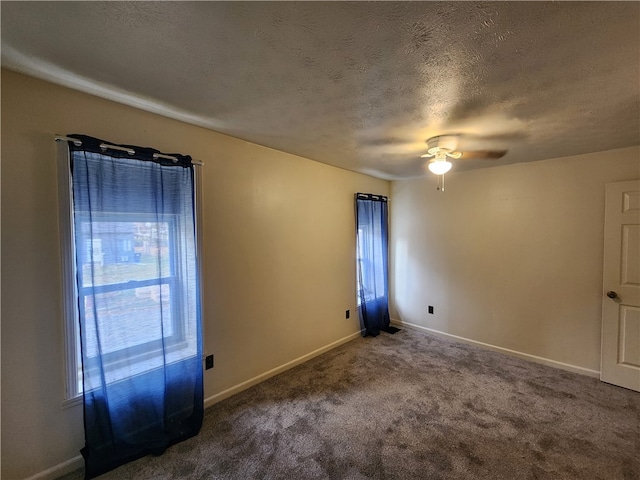 carpeted empty room with a textured ceiling and ceiling fan