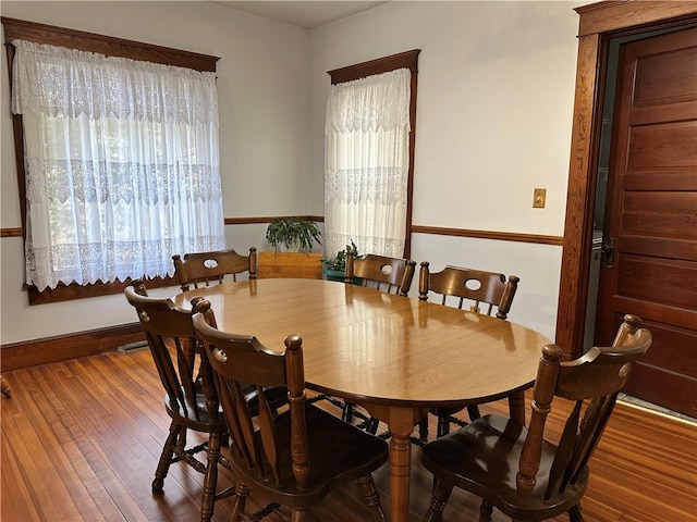 dining space featuring wood-type flooring and plenty of natural light