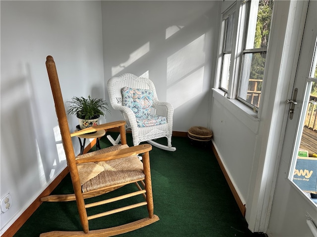 living area with a wealth of natural light and carpet floors