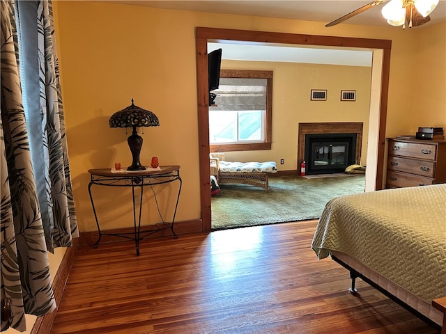 bedroom with ceiling fan and hardwood / wood-style flooring