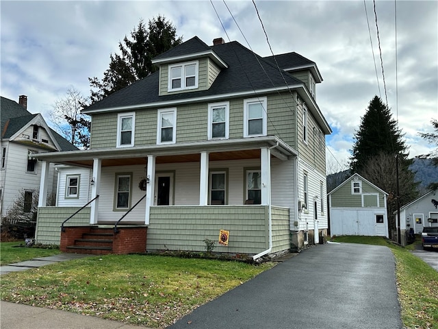 view of front of home with a porch and a front lawn