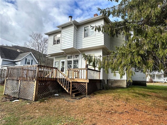 back of house featuring a yard and a wooden deck