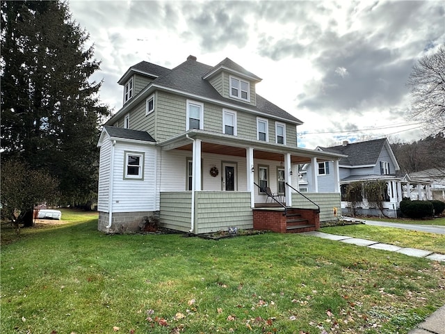 view of front of home with covered porch and a front yard