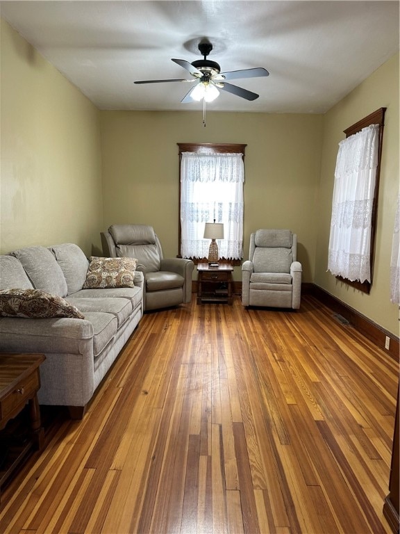 living room featuring hardwood / wood-style floors and ceiling fan