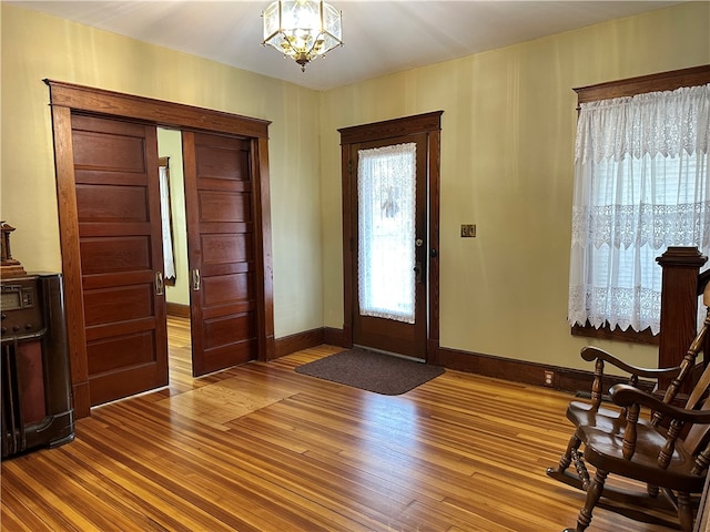 entryway featuring a chandelier and wood-type flooring