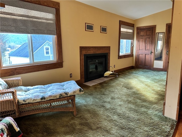 sitting room with carpet, a wealth of natural light, and lofted ceiling