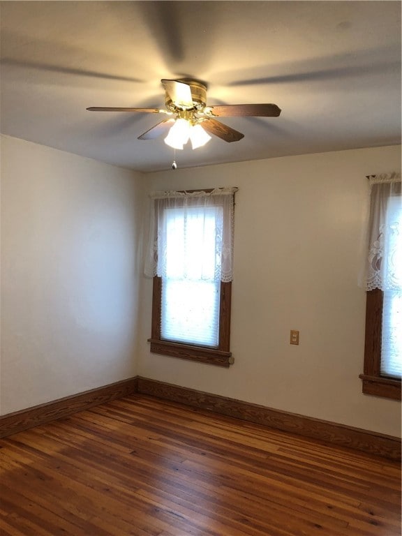 unfurnished room with dark hardwood / wood-style floors and ceiling fan