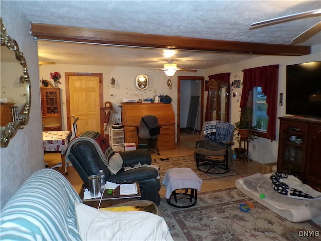 tiled living room with ceiling fan, beamed ceiling, and a textured ceiling