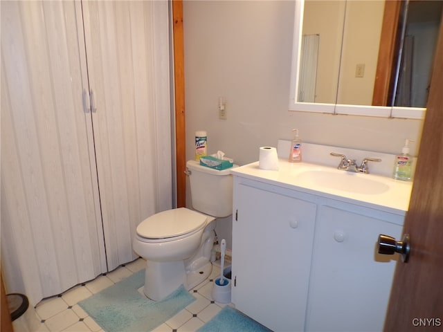 bathroom with tile patterned floors, vanity, and toilet