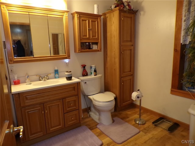 bathroom featuring hardwood / wood-style floors, vanity, and toilet