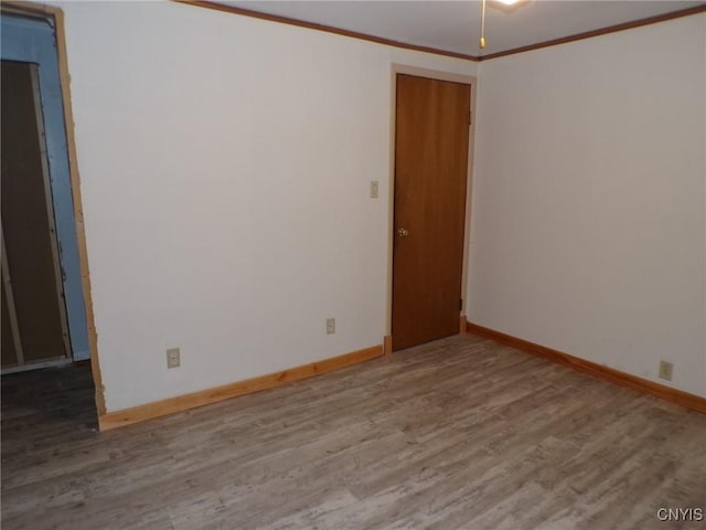 unfurnished room with ornamental molding and hardwood / wood-style floors