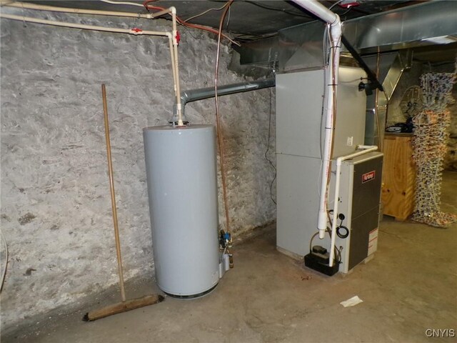 utility room featuring gas water heater and heating unit