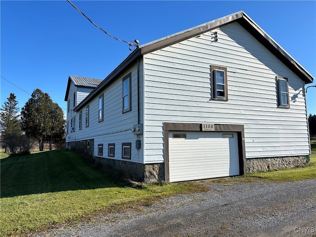 view of home's exterior featuring a garage and a yard