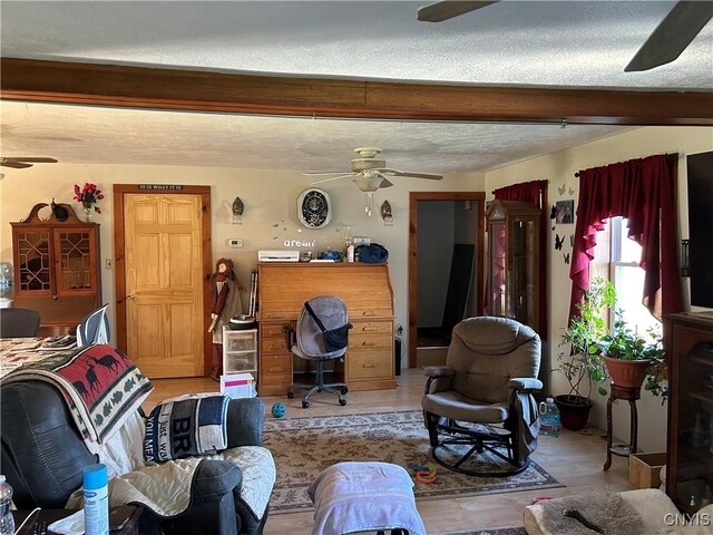 living room with a textured ceiling and light wood-type flooring