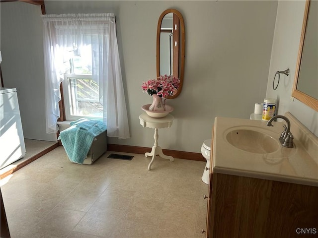 bathroom featuring vanity and toilet