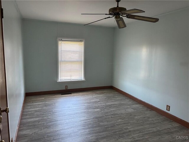 unfurnished room featuring ceiling fan, ornamental molding, and hardwood / wood-style flooring