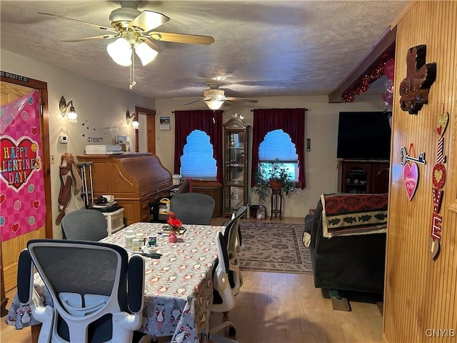 home office with ceiling fan, a textured ceiling, and light wood-type flooring